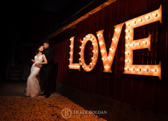 The Rustic wedding Barn love sign portrait newlyweds